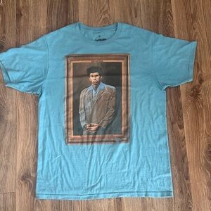 Aqua blue original Seinfeld Short-Sleeve Graphic Tee with “The Kramer” logo